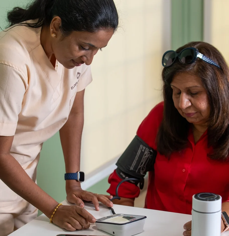 A nurse checking blood pressure at a wellness event