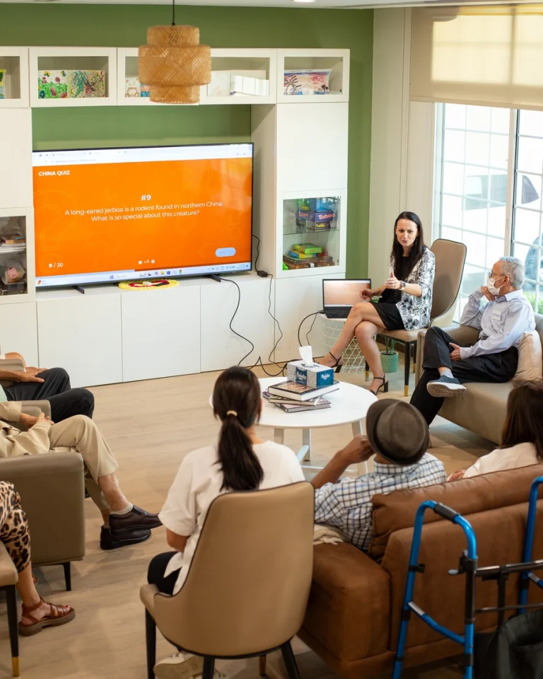 Seniors and caregivers gathered in the community lounge