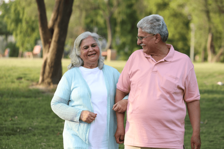 A senior couple walking in the park