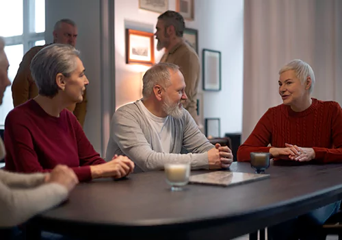 Seniors talking around a table